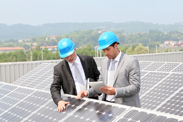 Ingenieros revisando la configuración de paneles solares —  Fotos de Stock
