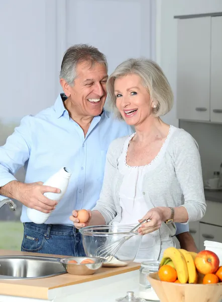 Äldre par i köket baka tårta — Stockfoto