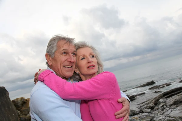 Deniz kenarında birbirlerine kucaklayan kıdemli mutlu çift — Stok fotoğraf