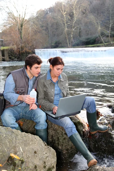 stock image Biologists testing water of natural river