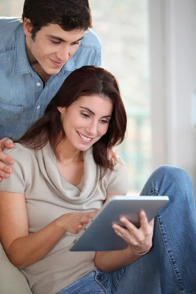 Junges Paar nutzt elektronisches Tablet zu Hause — Stockfoto