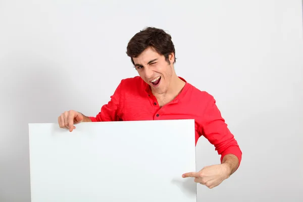 Portrait of young man holding whiteboard — Stock Photo, Image