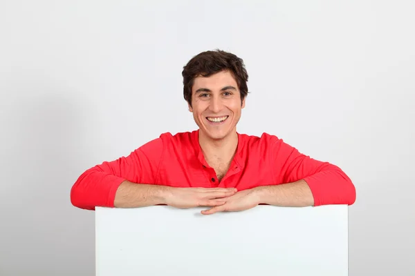 Portrait of young man holding whiteboard — Stock Photo, Image