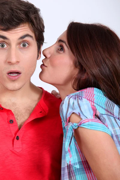 Young woman trying to give a kiss to her boyfriend — Stock Photo, Image