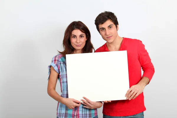 Couple holding whiteboard — Stock Photo, Image