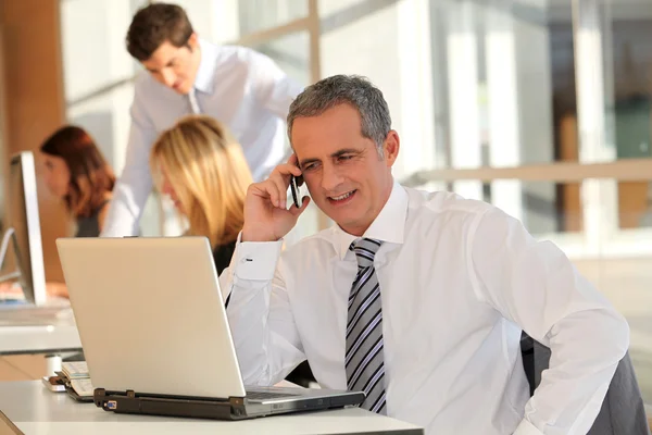 Businessman in the office talking on the phone — Stock Photo, Image