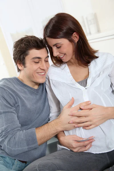 Future father listening to heartbeat of baby — Stock Photo, Image