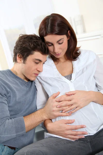 Future father listening to heartbeat of baby — Stock Photo, Image