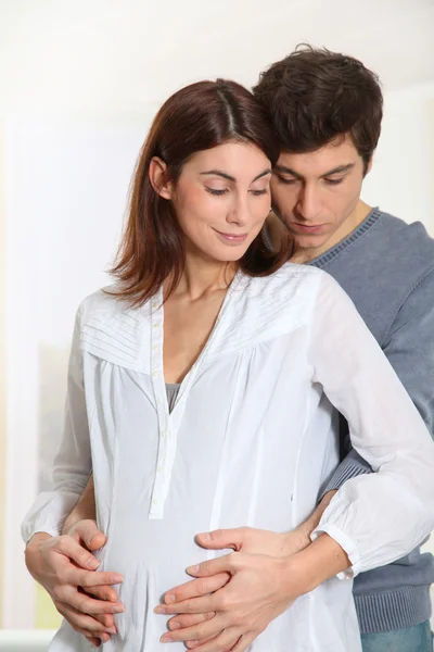 Parents with hands on pregnant woman's belly — Stock Photo, Image