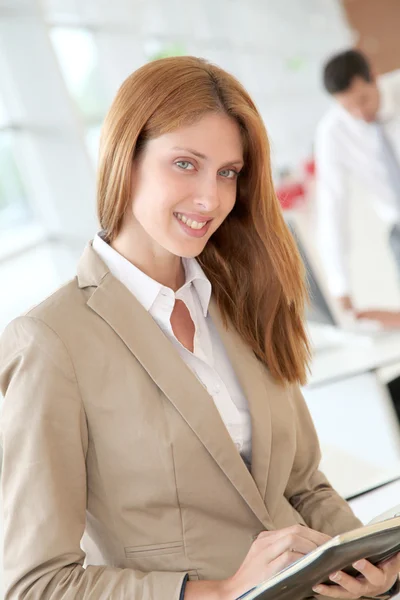 Beautiful woman in office with agenda — Stock Photo, Image