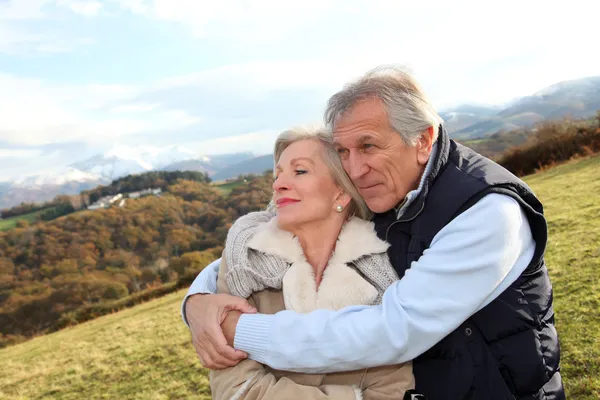 Portrait of happy senior couple in countryside Stock Photo