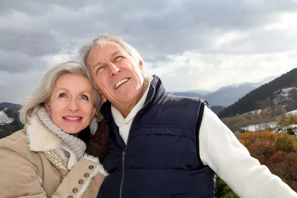 Portrait of happy senior couple at the mountain Stock Image