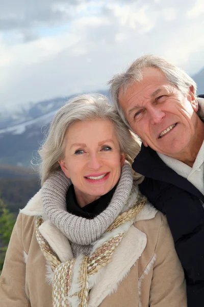 Portrait of happy senior couple at the mountain Stock Image