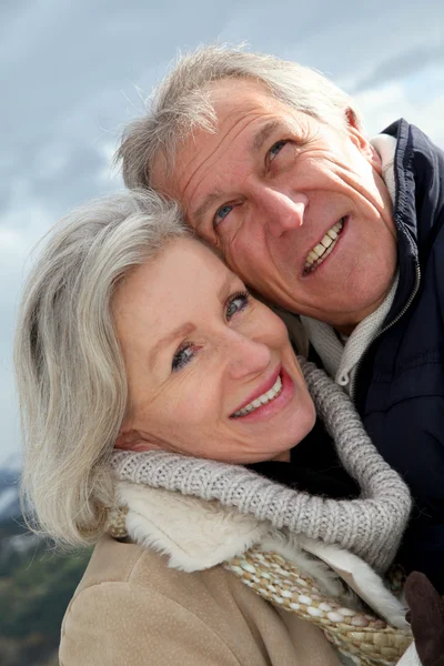 Portrait of happy senior couple at the mountain Stock Photo