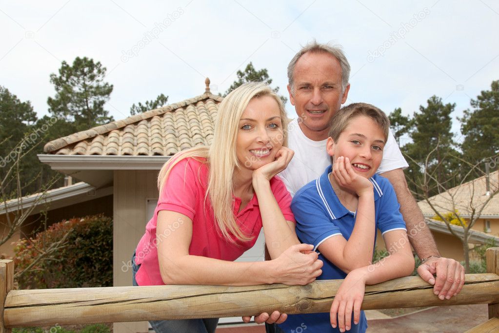 Family standing in front of their house