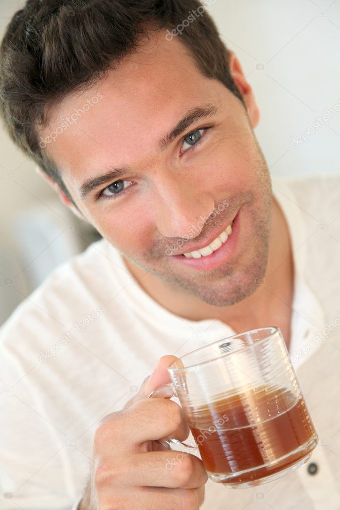 Portrait of man holding cup of tea