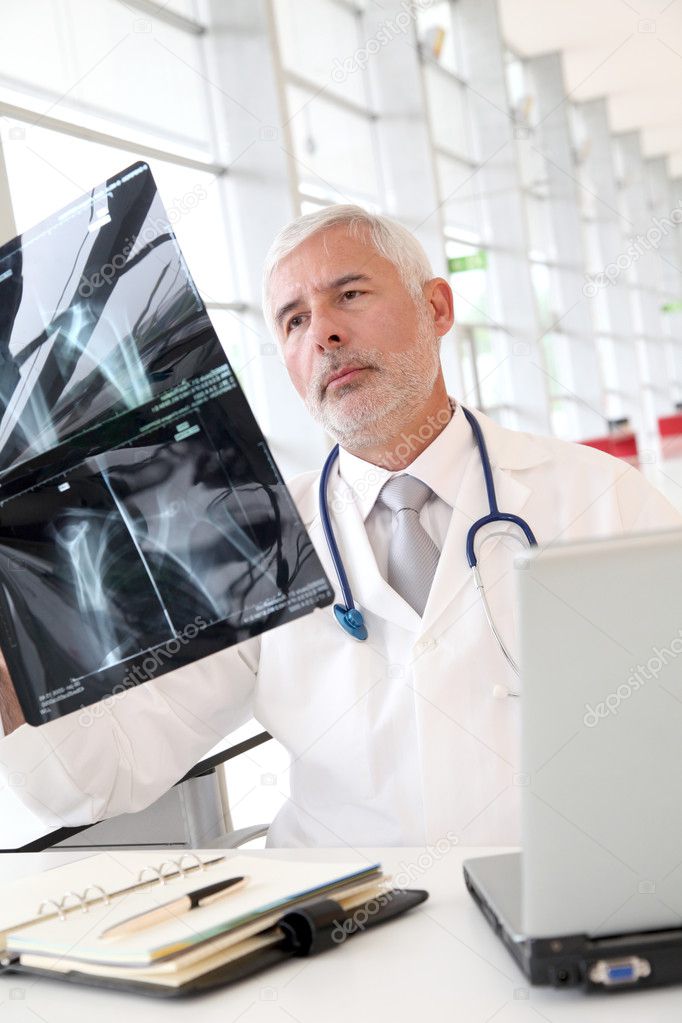 Senior doctor checking xray results