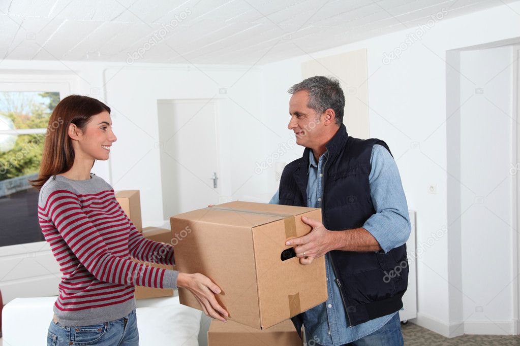 Young woman with removal man holding boxes