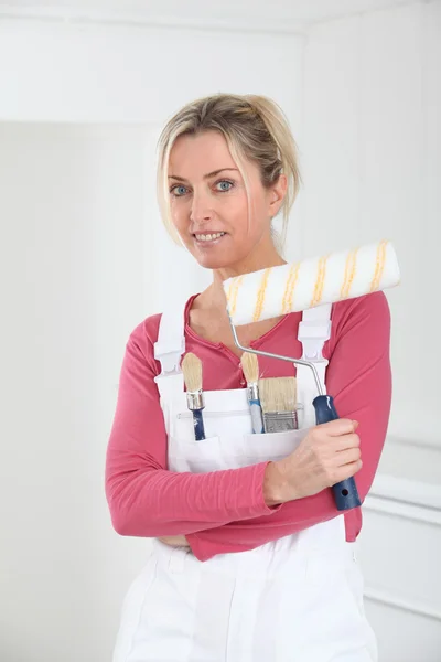 Beautiful blond woman with paint roller — Stock Photo, Image