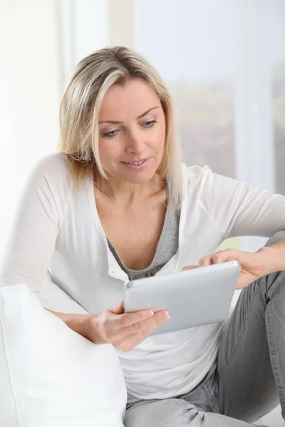 Femme blonde utilisant une tablette électronique à la maison — Photo