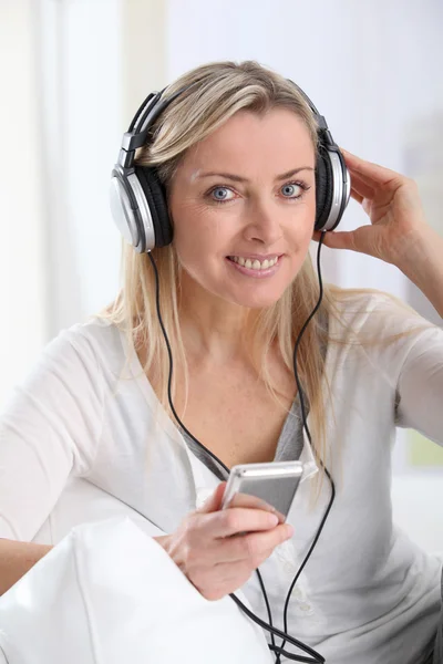 Portrait of beautiful blond woman with headphones on — Stock Photo, Image