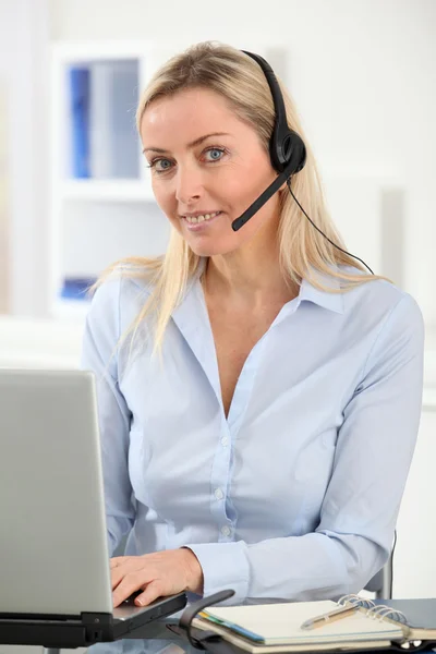 Closeup on blond woman with headset on — Stock Photo, Image