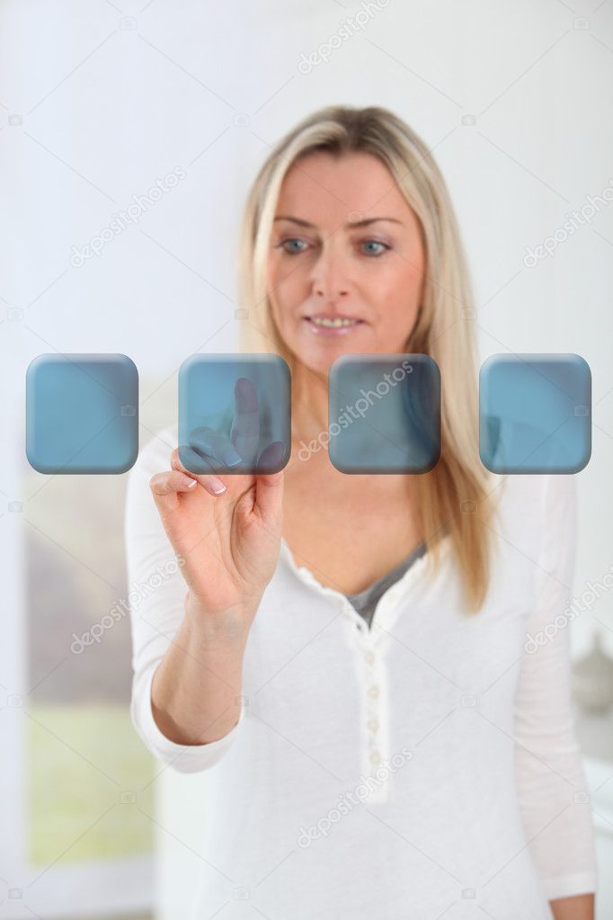 Blond woman touching virtual screen