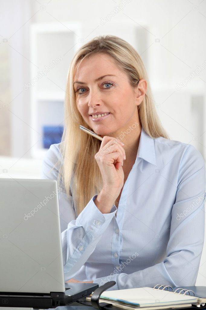 Beautiful office worker talking on the phone — Stock Photo © Goodluz ...