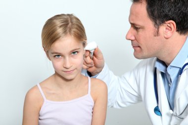 Doctor doing child medical check-up clipart