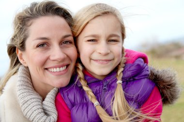 Portrait of smiling mother and daughter clipart