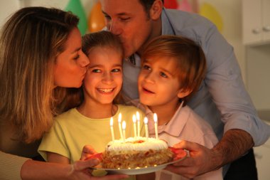 Family celebrating child's birthday clipart