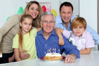 Family celebrating grandfather's birthday clipart