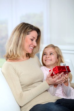 Little girl offering present to her mom clipart