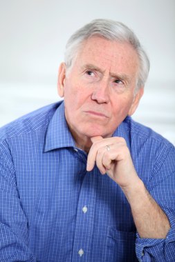 Portrait of smiling old man with thoughtful look clipart