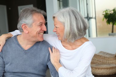 Happy senior couple looking at each other clipart