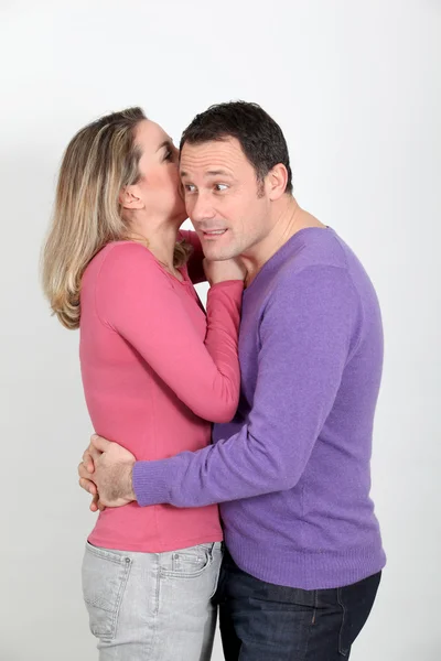 Woman whispering to her boyfriend's ear — Stock Photo, Image