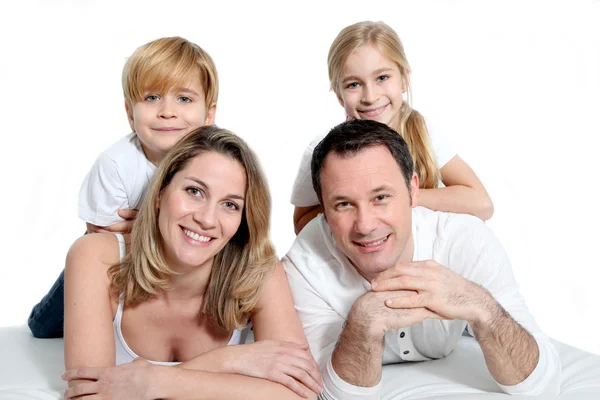 Happy family laying on bed — Stock Photo, Image