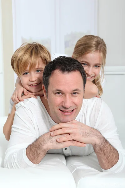 Портрет отца с детьми на спине — стоковое фото
