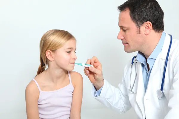 Arzt überprüft Temperatur des kleinen Mädchens — Stockfoto