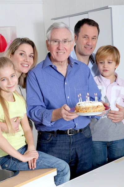 Family celebrating grandfather's birthday — Stock Photo, Image