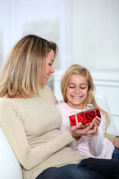 Little girl offering present to her mom — Stock Photo, Image