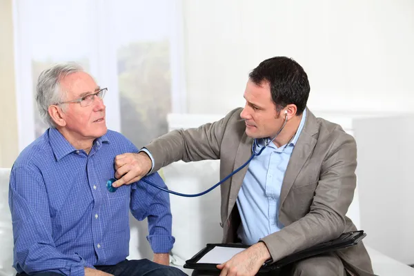 Lékař zkoumá starší muž zdraví — Stock fotografie