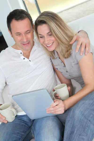 Пара дома с помощью электронного планшета — стоковое фото