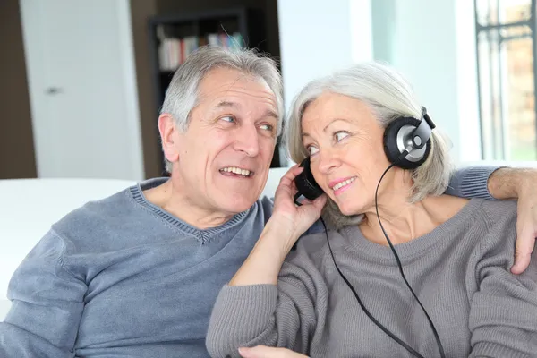 stock image Senior couple listening to music with headphones