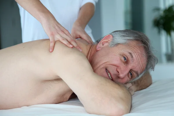 Senior man having a massage — Stock Photo, Image