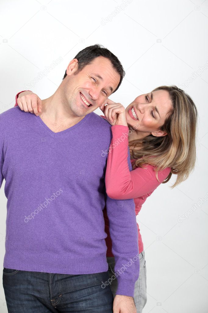 Woman pulling on her boyfriend's cheek
