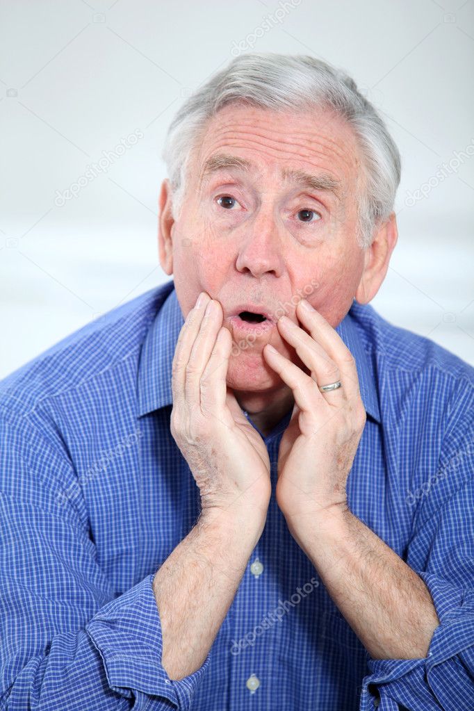 Portrait of suprised elderly man
