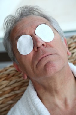 Senior trying to ease eyes pain clipart
