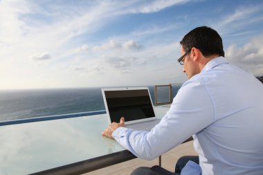Man working in front of the sea clipart