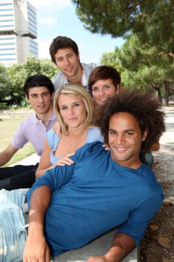 Group of happy students in a park clipart